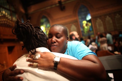 NEW YORK, NY - JULY 14:  People hug during services at Middle Collegiate Church in Manhattan honoring Trayvon Martin on July 14, 2013 in New York City. George Zimmerman was acquitted of all charges in the shooting death of Martin July 13 and some congregants wore hoodies during the service to honor Martin.  (Photo by Mario Tama/Getty Images) ORG XMIT: 173735708